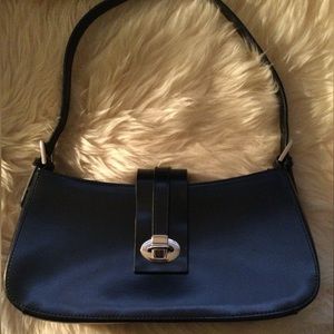 CNKW black leather purse with silver hardware.